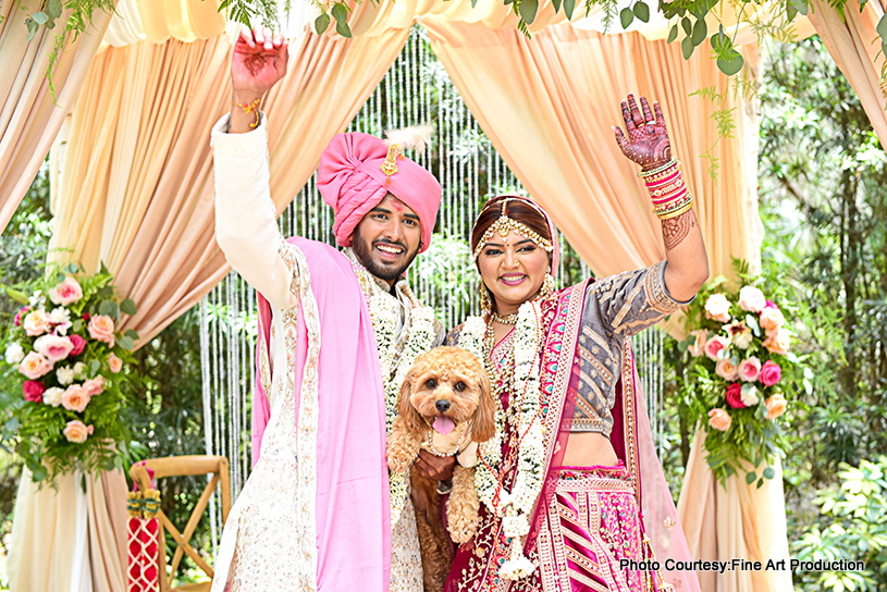 indian wedding couple posing for photoshoot with pet