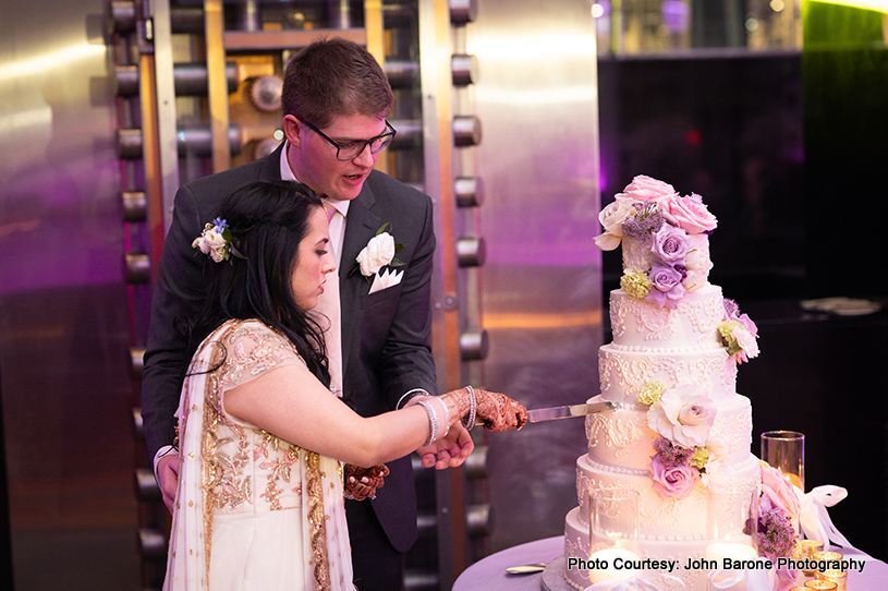 Indian wedding couple cuts wedding cake