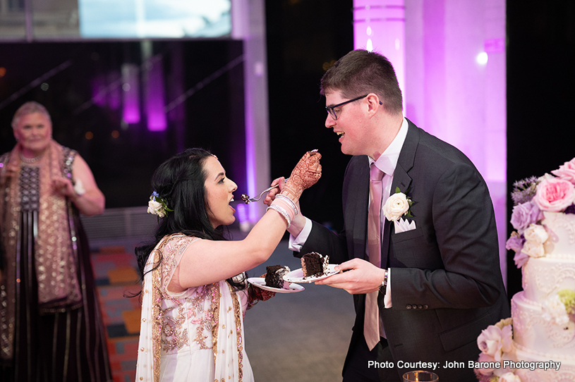 Indian wedding couple feeding cake each other